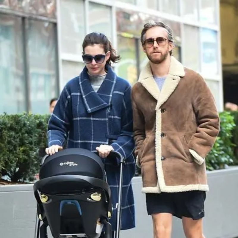 Anne Hathaway and Adam Shulman taking their kid on a walk.